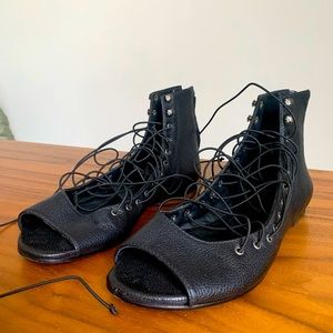 Black leather sandals. Edgy ties! Zipped in the back. Size 6.